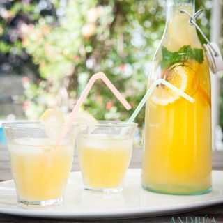 Ice tea with orange and lemon and two glasses