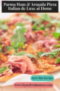 A slice of pizza with Parma ham, arugula, and pine nuts. The text at the top reads: Parma Ham & Arugula Pizza – Italian de Luxe at Home