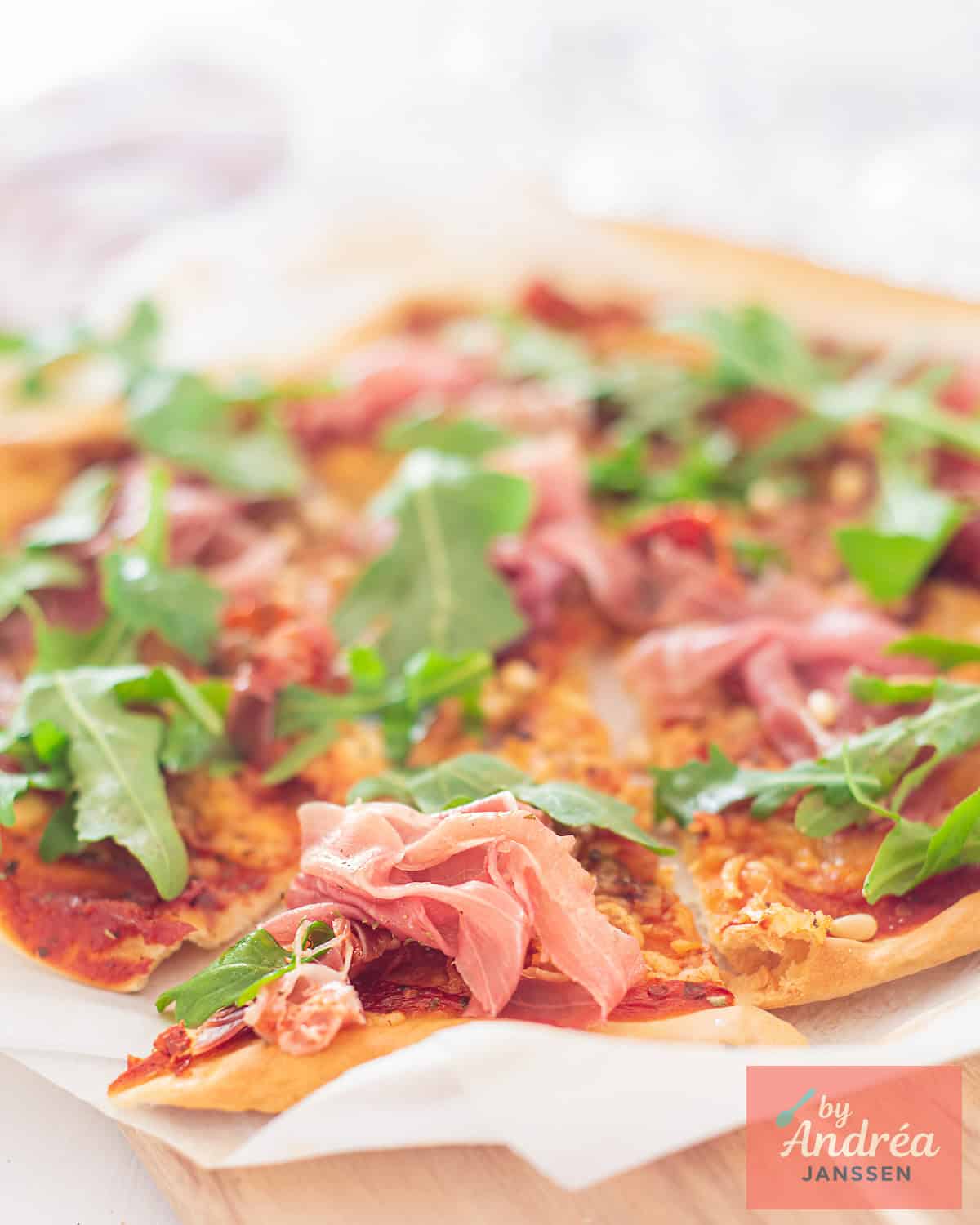 A pizza with Parma ham, rocket and pine nuts