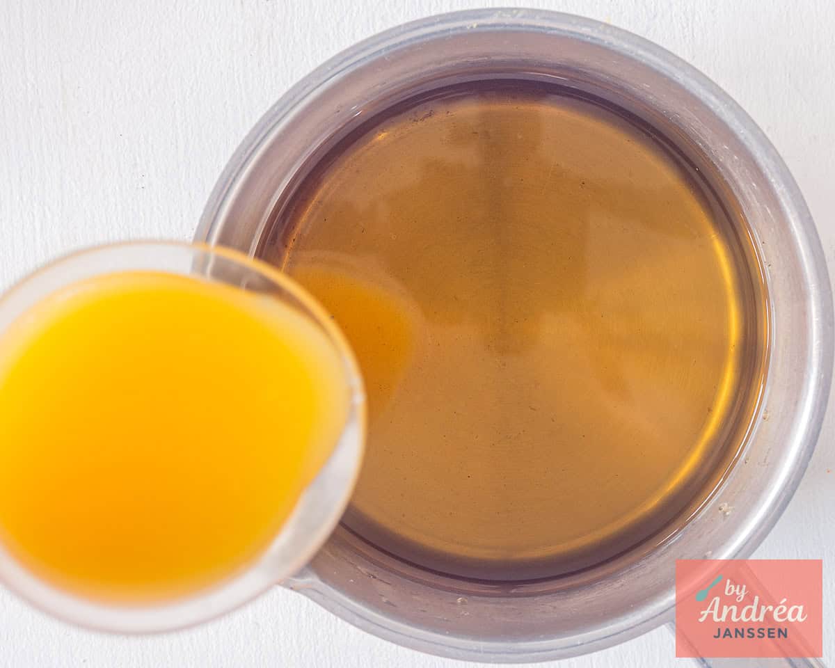 Freshly squeezed orange juice in a measuring jug for homemade iced tea
