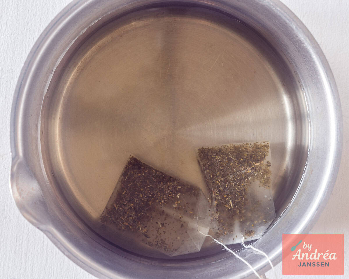 4) Green tea bags steeping in hot sweetened water for homemade orange iced tea