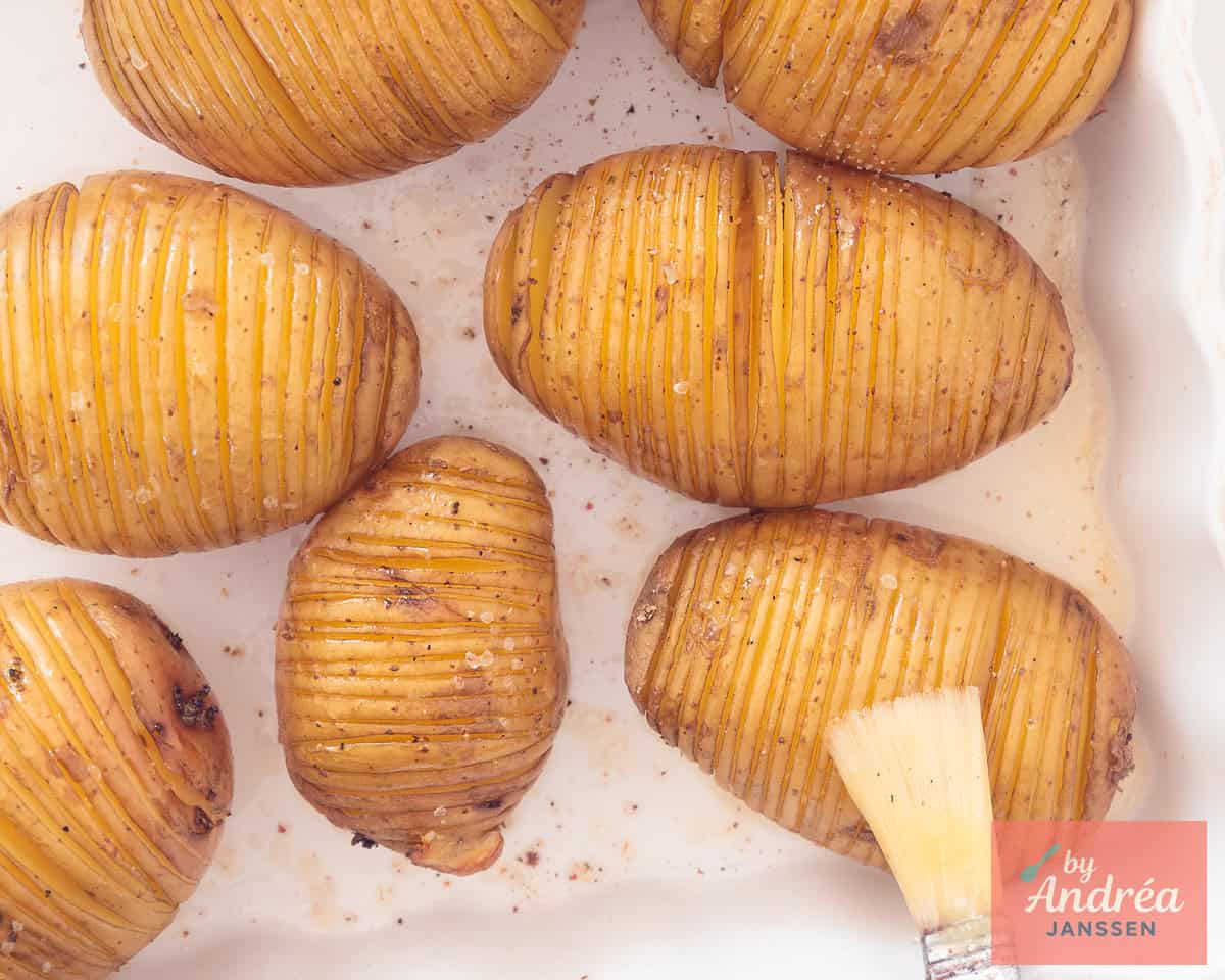 Sliced   potatoes are brushed with melted butter