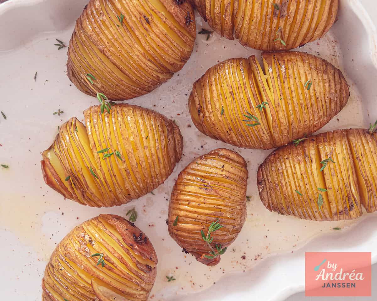 Hasselback potatoes in a casserole dish fresh from the oven.