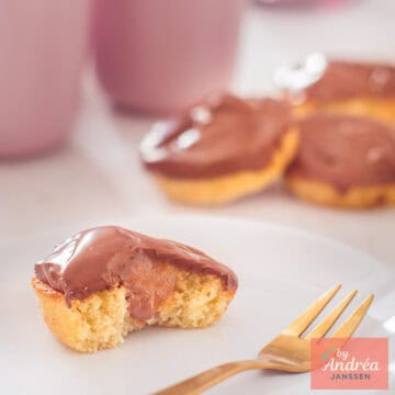 A square picture with 4 twix style cupcakes. One is halved so you can see the insides.