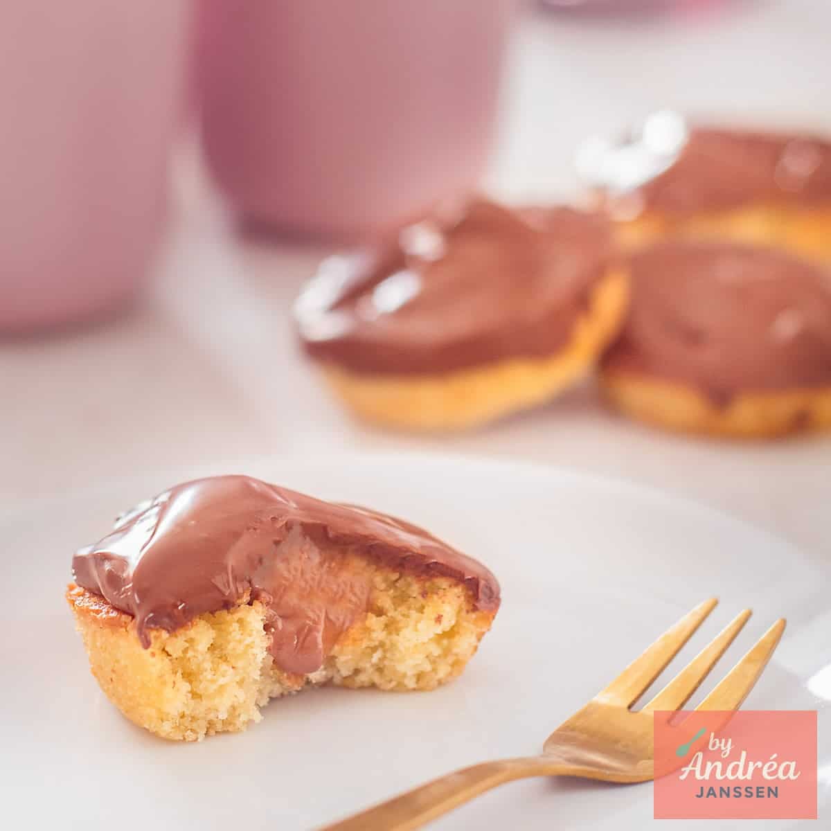 A square picture with 4 twix style cupcakes. One is halved so you can see the insides.