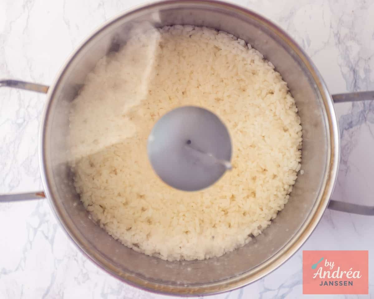 Sushi rice cooked in a pan with lid on.