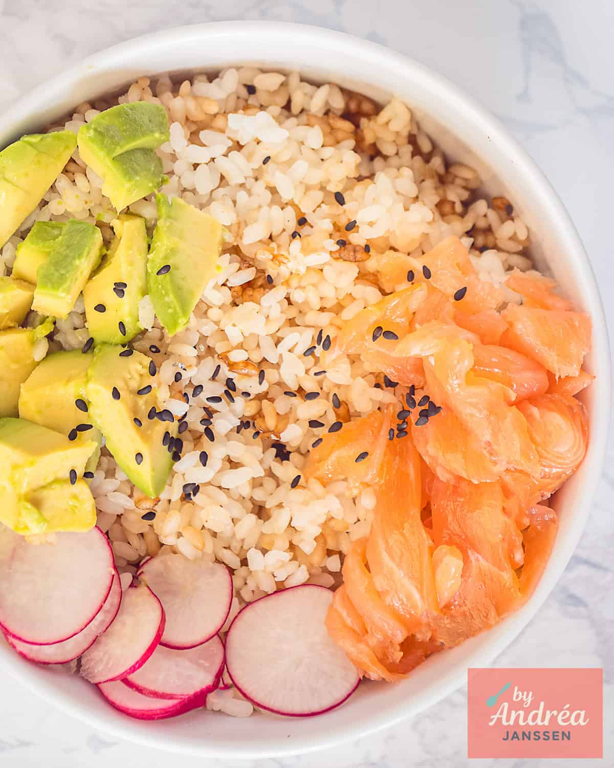 A top down picture of a sushi bowl with smoked salmon, radishes, avocado