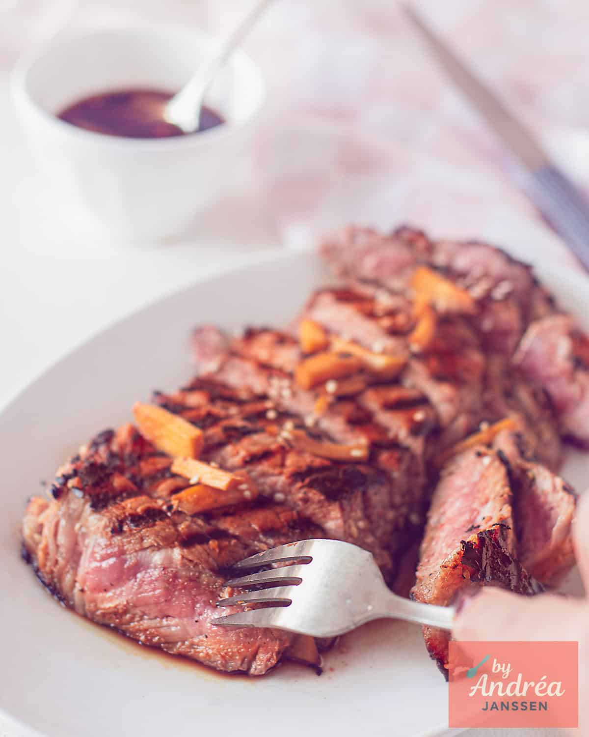 Strips of entrecote with soy ginger sauce on a white background