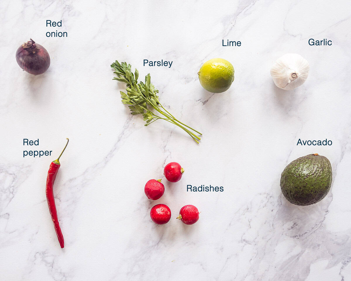 Ingredients Avocado radish salsa on a white marbled background with text description