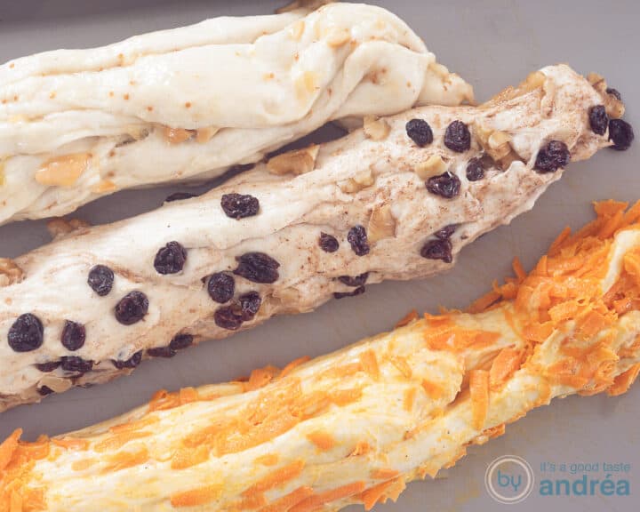 Three strands of dough in different flavors on a gray background