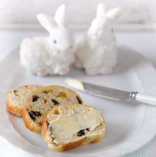 slices Easter stollen with orange and cinnamon on a white plate