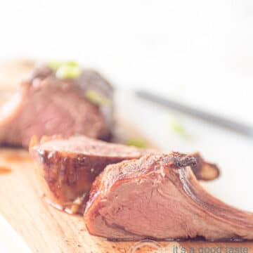A wooden plate with lamb chops