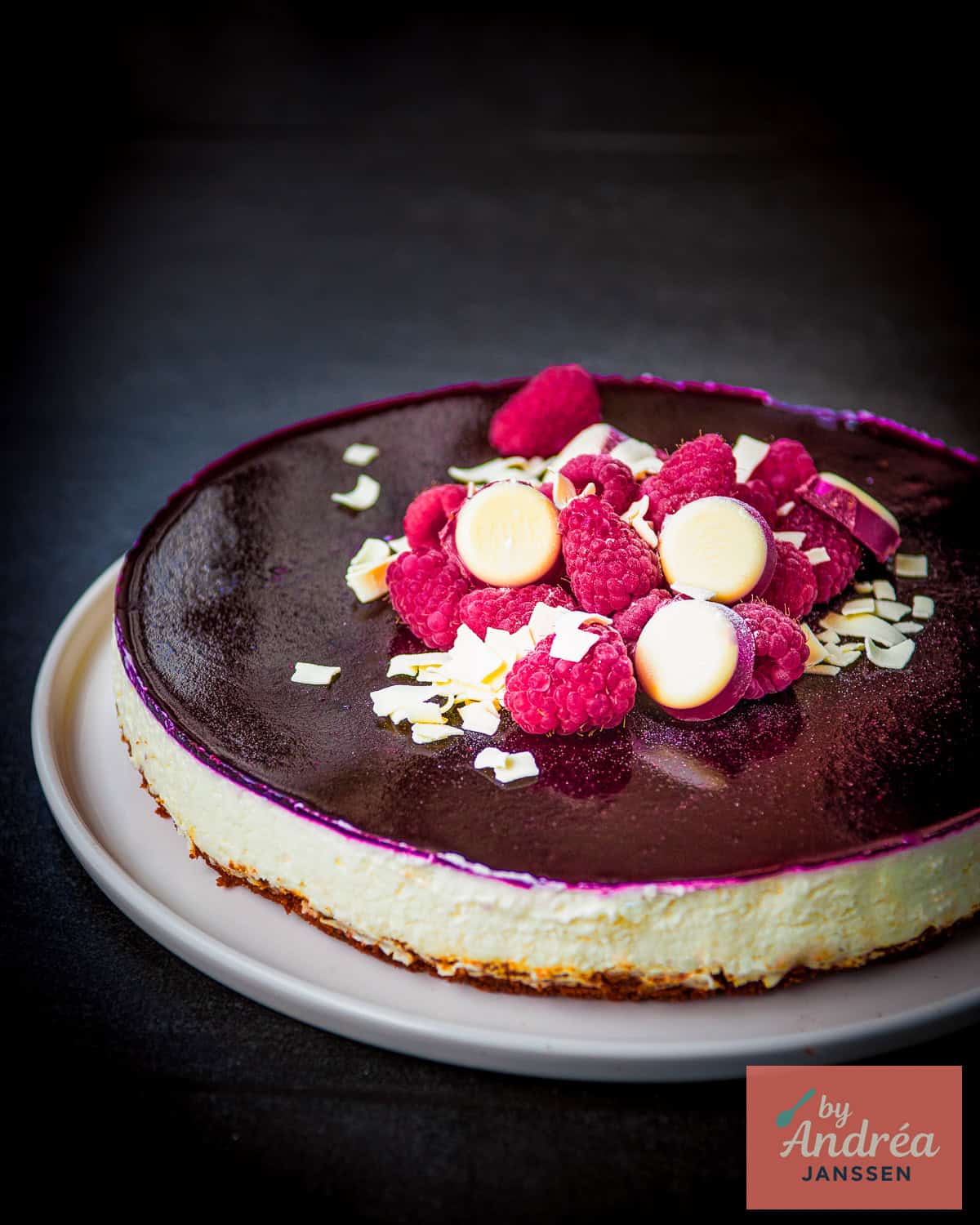 A no bake white chocolate cheesecake with forest fruit topping.