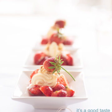 three white plates with fresh strawberries and cream
