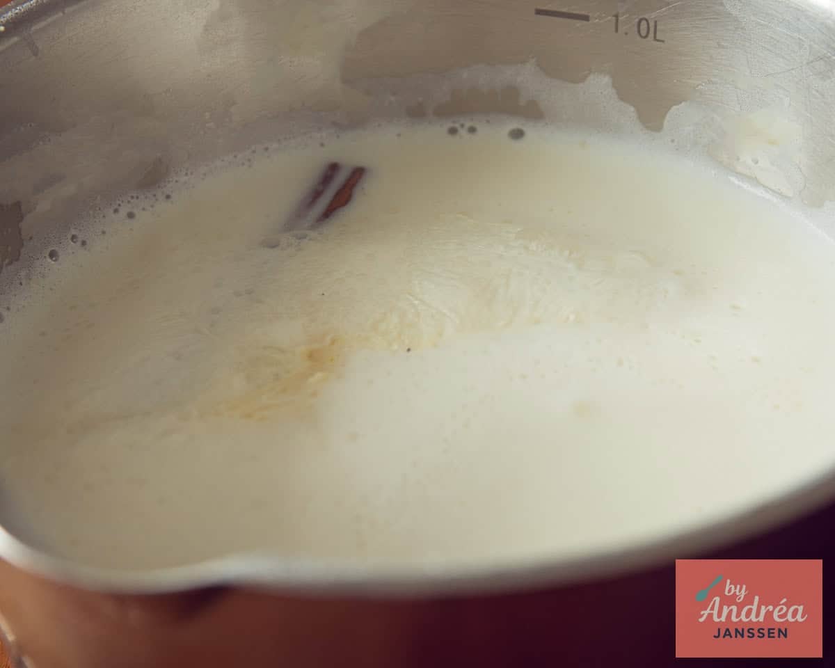 Flavor milk in a saucepan with lemon and cinnamon