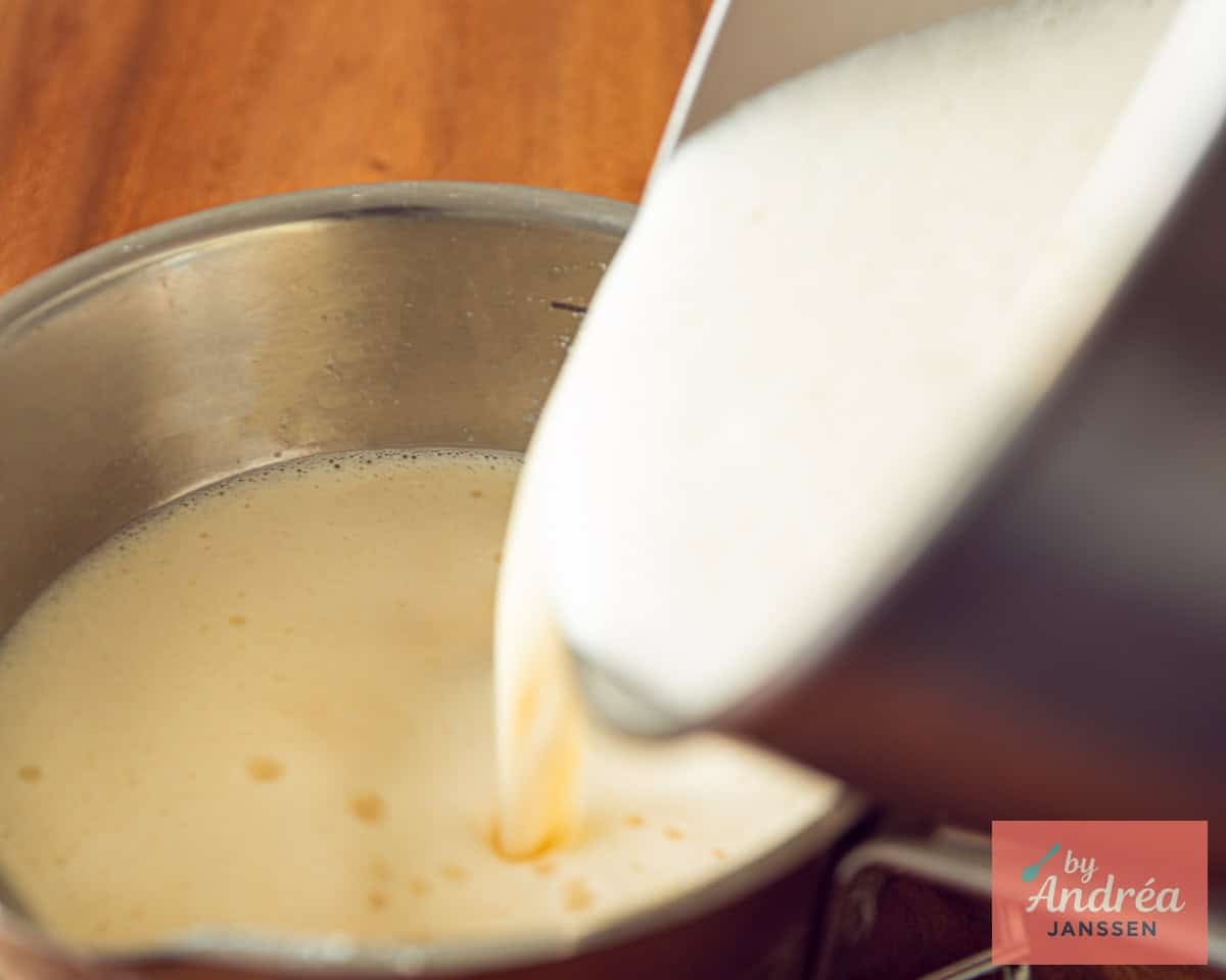 Add hot milk to the egg yolks mix