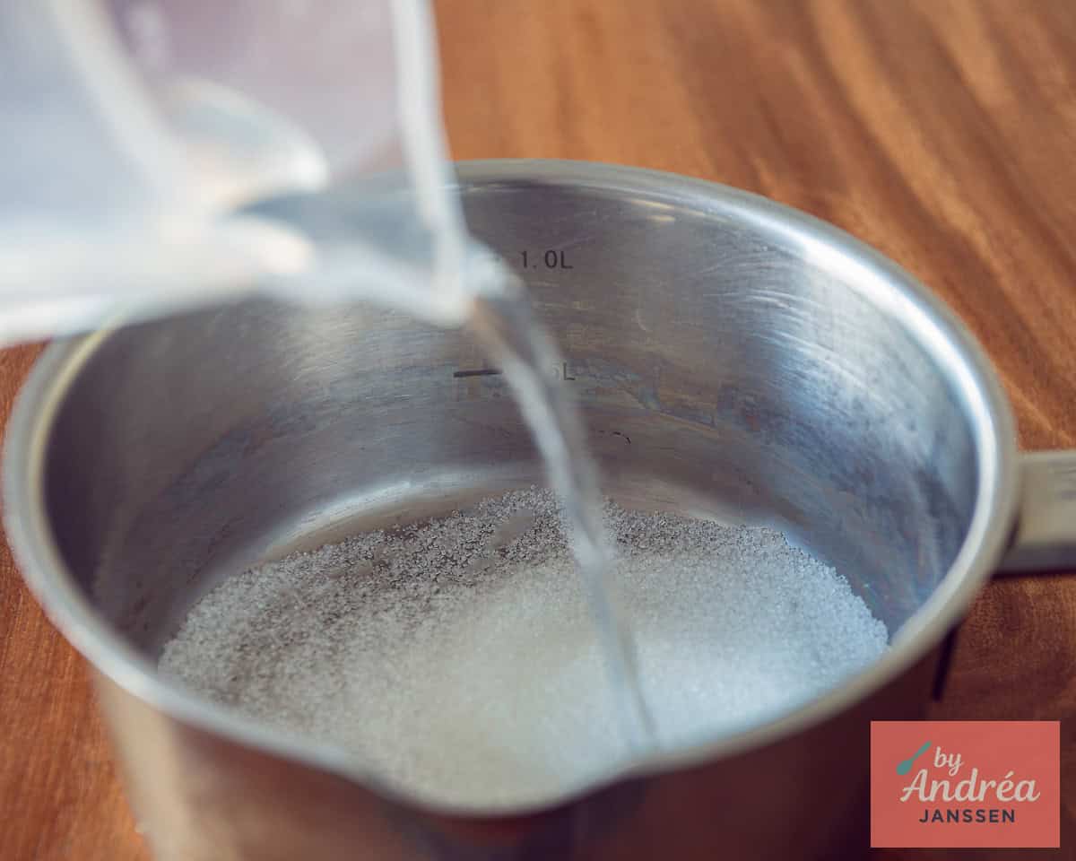 In a saucepan, add water to the sugar.