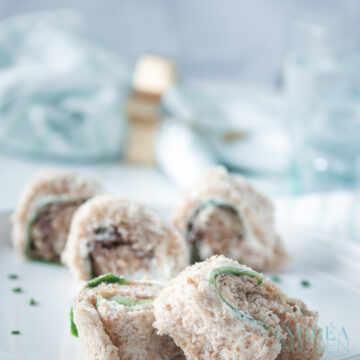 a plate with sandwiches rolls with smoked mackerel and cucumber
