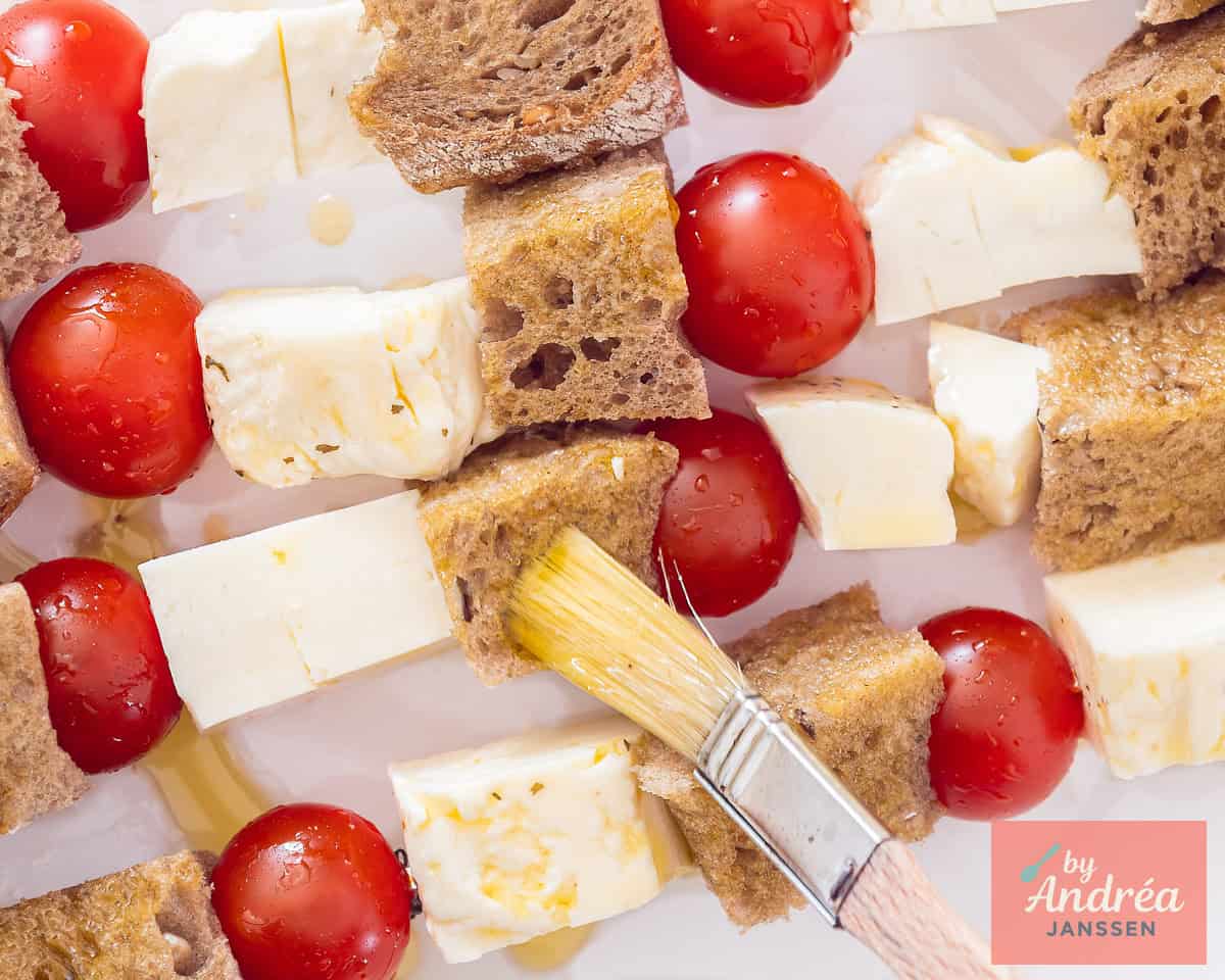 Brush the bread with garlic oil.