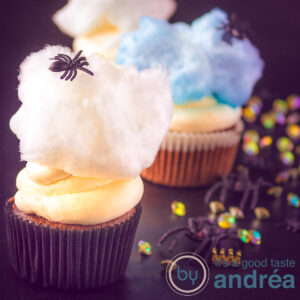 Spider cupcakes with mascarpone frosting and cotton candy on a black background