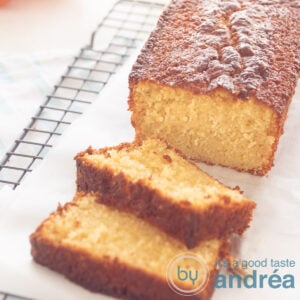 tangerine cake in a cake tin. Two slices in front and some tangerine parts