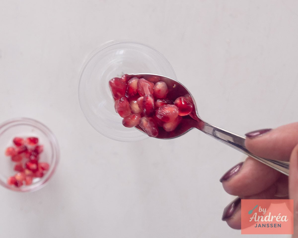 Scoop some pomegranate seeds into the champagne flute