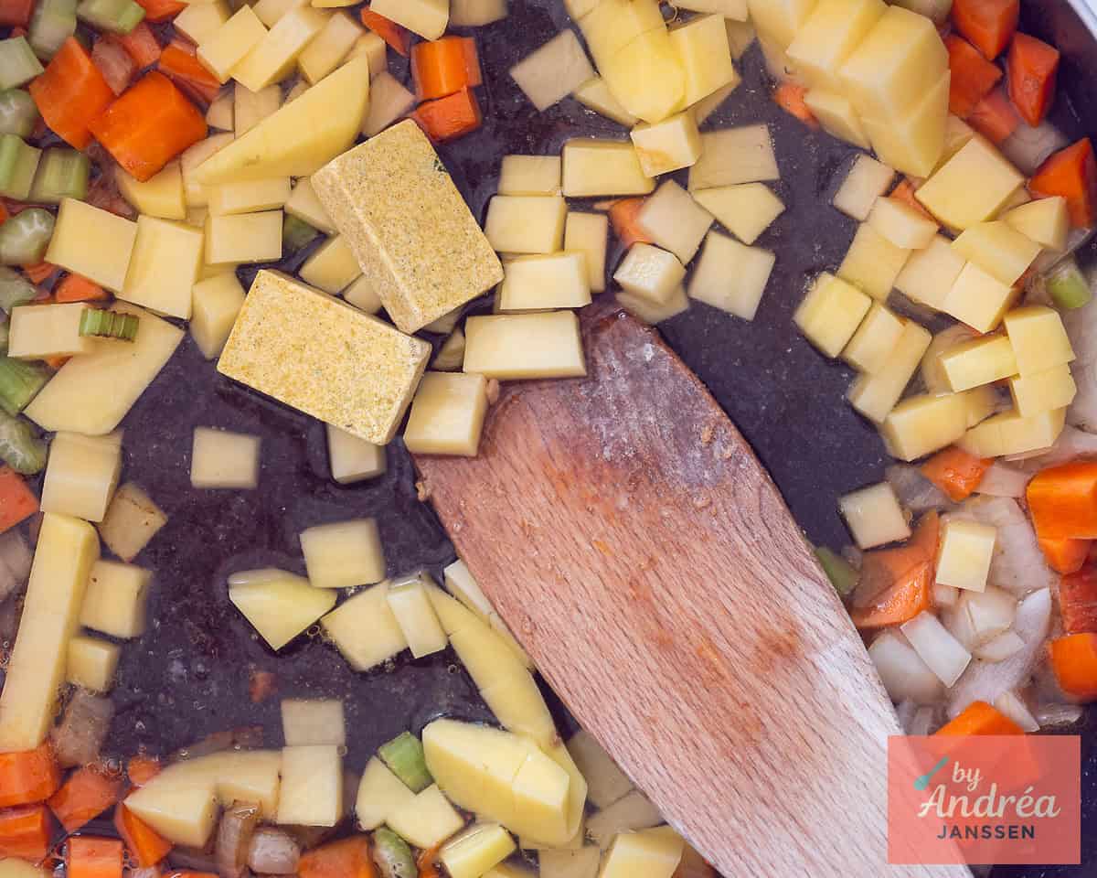Creamy chicken pot pie filling with potatoes, carrots and peas in a pan