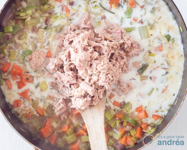 Tuna is added to a pan with vegetables and sauce