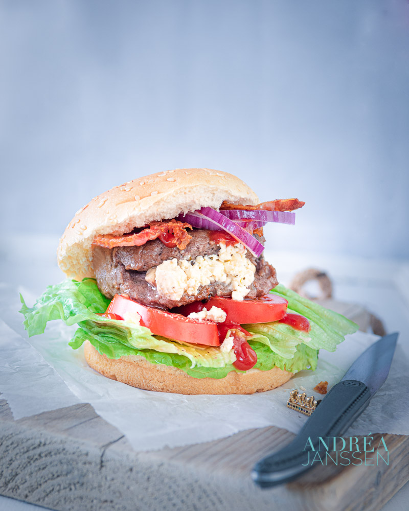 Hamburger with a bun the luxe on a wooden board