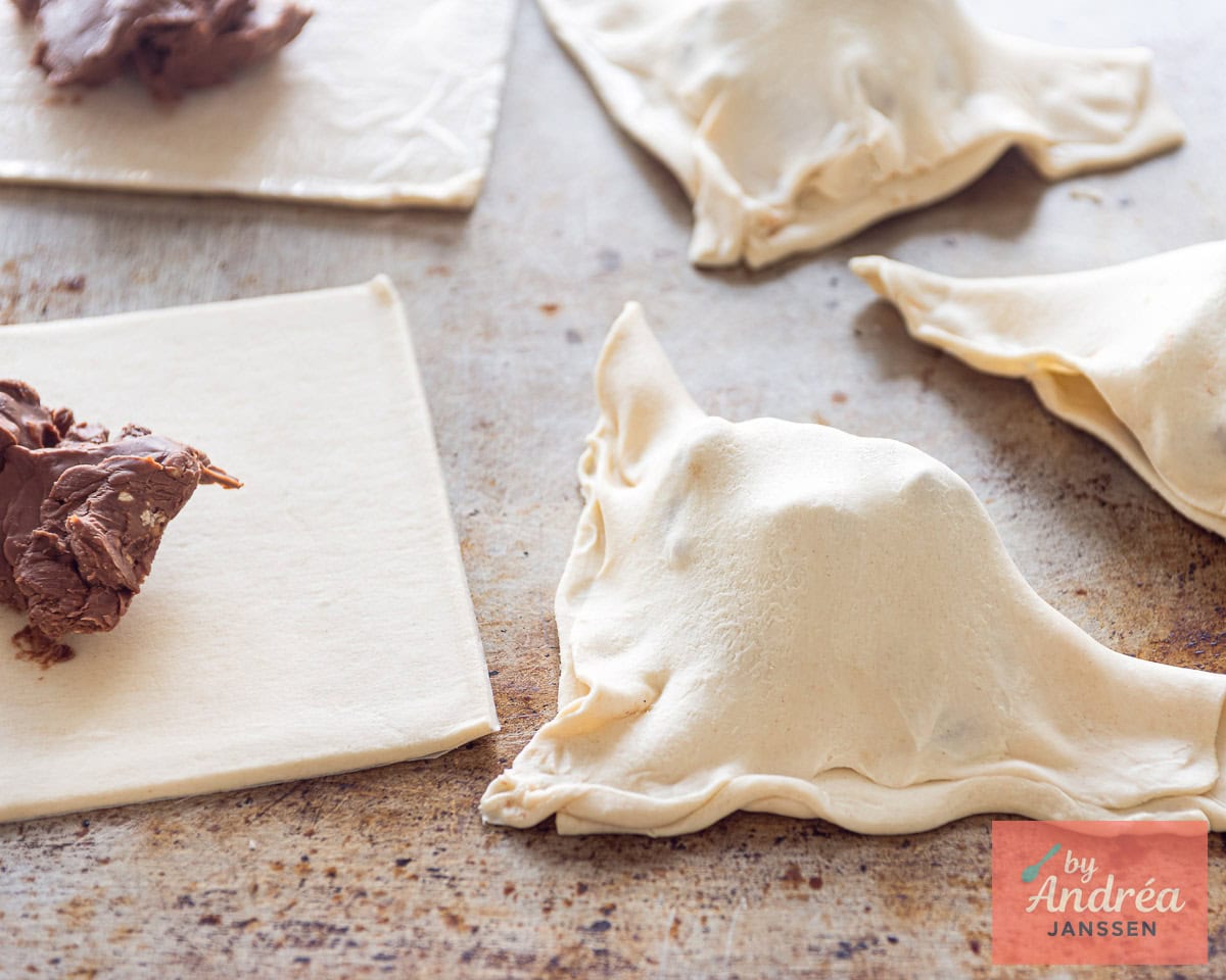 Puff pastry folded into a triangle with chocolate hazelnut caramel filling