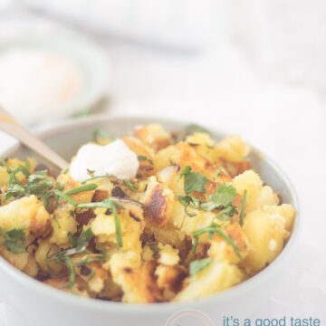 Baked potatoes with green herbs and garlic yogurt sauce