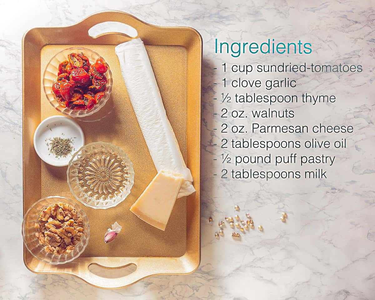 Ingredients for puff pastry Christmas tree with red pesto on a golden tray. A text description of the ingredients next to it.