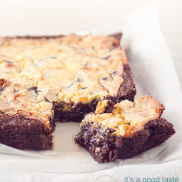 Cheesecake brownie with a square loose at the bottom on a baking paper