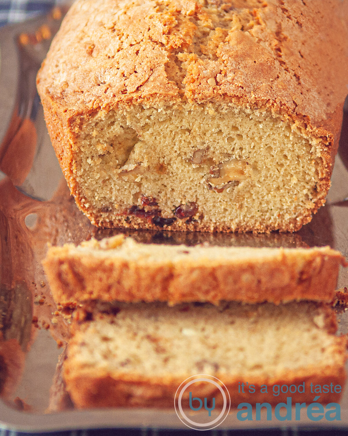 a cranberry walnut coffee cake on a silver platter. Two slices cut off.