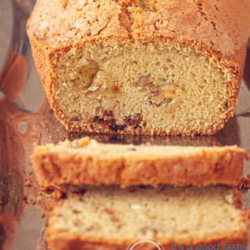 a cranberry walnut coffee cake on a silver platter. Two slices cut off.