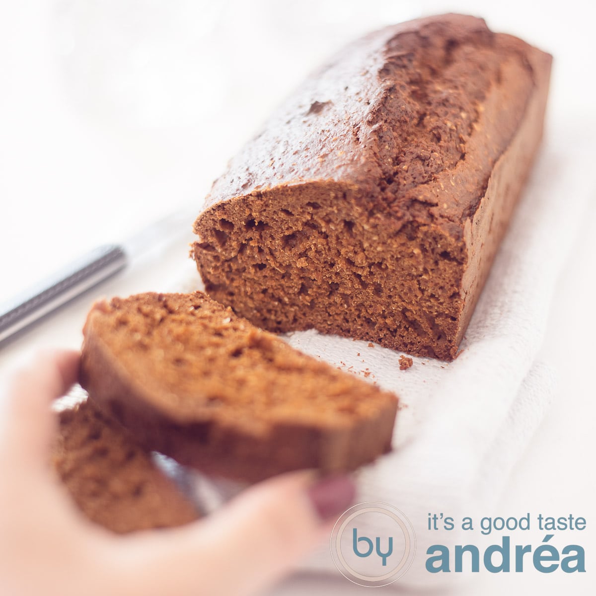 A square photo with a gingerbread without refined sugars. A slice cut off that is taken. Everything on a white background