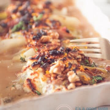a fork taking some chicory wrapped in Prosciutto, goat cheese and orange