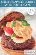 A hamburger bun with mozzarella, tomato, and pesto. Mayonnaise. A caption at the top reads: "Easy recipe, Grilled Caprese Burger with Pesto Mayo."