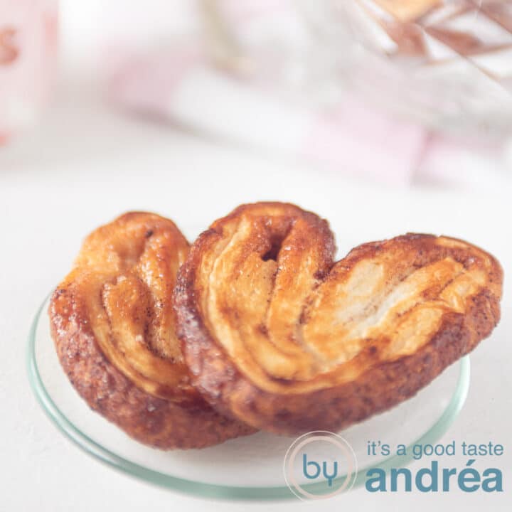 two palmier cookies on a glass plate a square photo