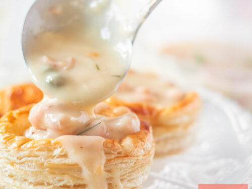 A square photo with a homemade pastry shell (Dutch vol-au-vent) into which ragout is being spooned.