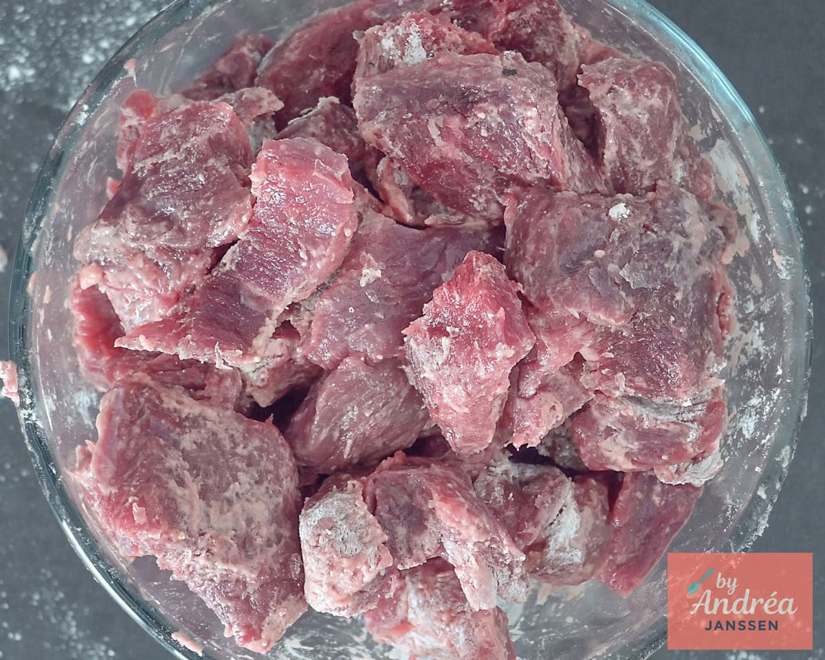Beef coated with flour and seasoned with salt and pepper.
