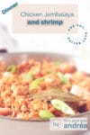 An aluminum pan with rice, shrimp, chicken and sausage. A text overlay describes the photo.