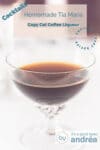 A glass filled with coffee liqueur on a white background. A text overlay describes the photo.