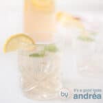 A square photo with two glasses of lemon and ginger lemonade with mint and lemon