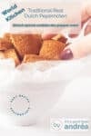 A white bowl on a white background filled with gingerbread cookies. A hand grabbing a gingerbread. A test overlay describing what's in the photo traditional real dutch pepernoten, dutch spiced cookies, peppernuts, worldkitchen, easy recipe, sinterklaas