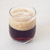 A glass filled with brown dark beer