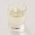 A glass filled with sunflower oil on a white background