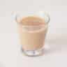 A glass filled with Baileys on a white background