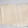 Dough stretched out on a white surface.