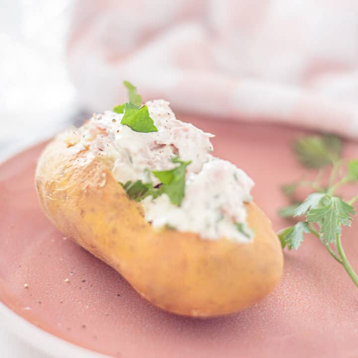 baked potato with herbed cottage cheese on a plate